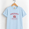 Poor Judgment Society Lifetime Member tee in Chambray on a wooden hanger, deep red lettering
