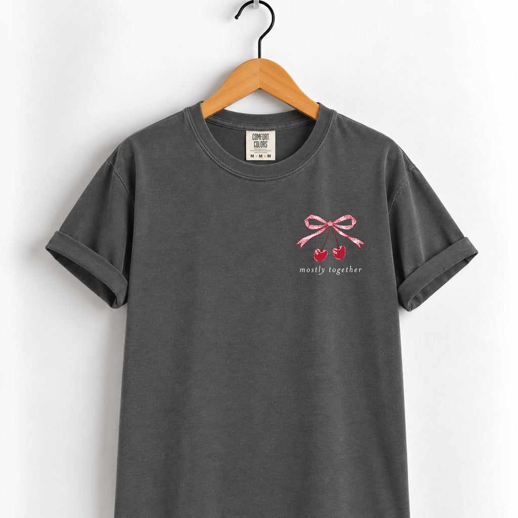 Mostly Together cherry bow tee in Pepper on a wooden hanger