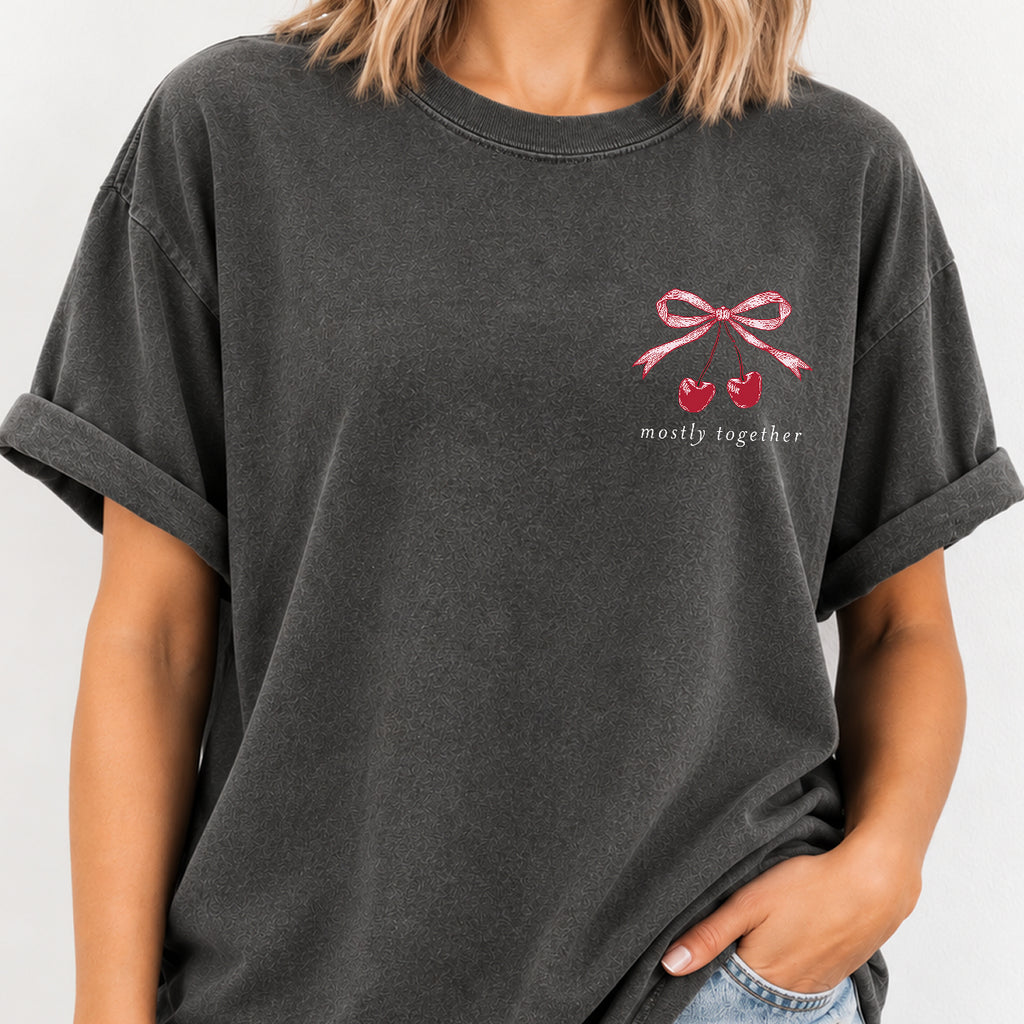 Woman wearing the Mostly Together cherry bow tee in Pepper