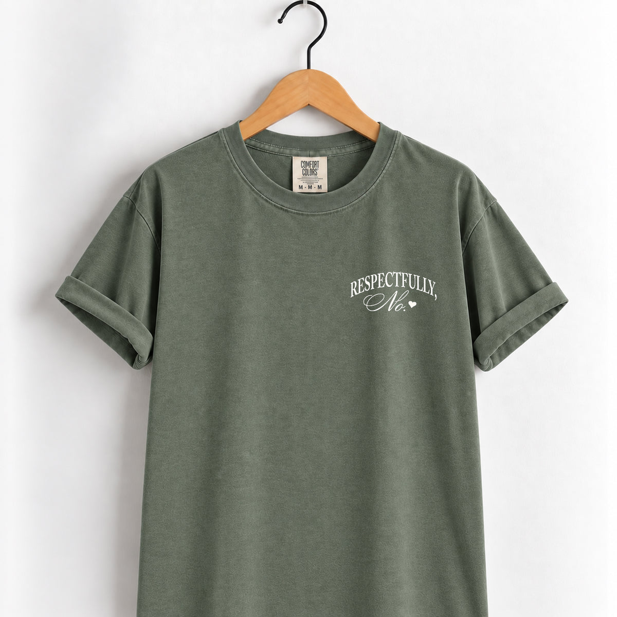 Respectfully, No tee in Moss on a wooden hanger, white left-chest script
