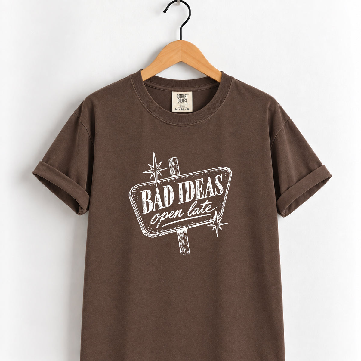 Bad Ideas, Open Late retro sign tee in Espresso on a wooden hanger, printed in cream