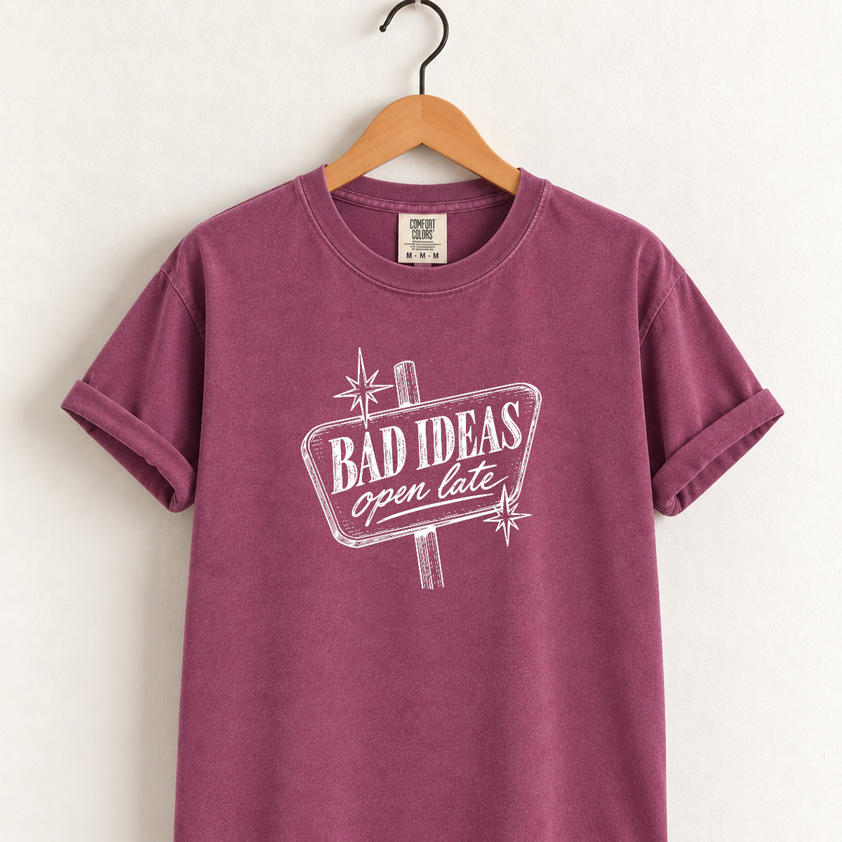 Bad Ideas, Open Late retro sign tee in Berry on a wooden hanger