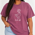 Woman wearing the Duck Off tee in Berry with jeans, blush duck design on the chest