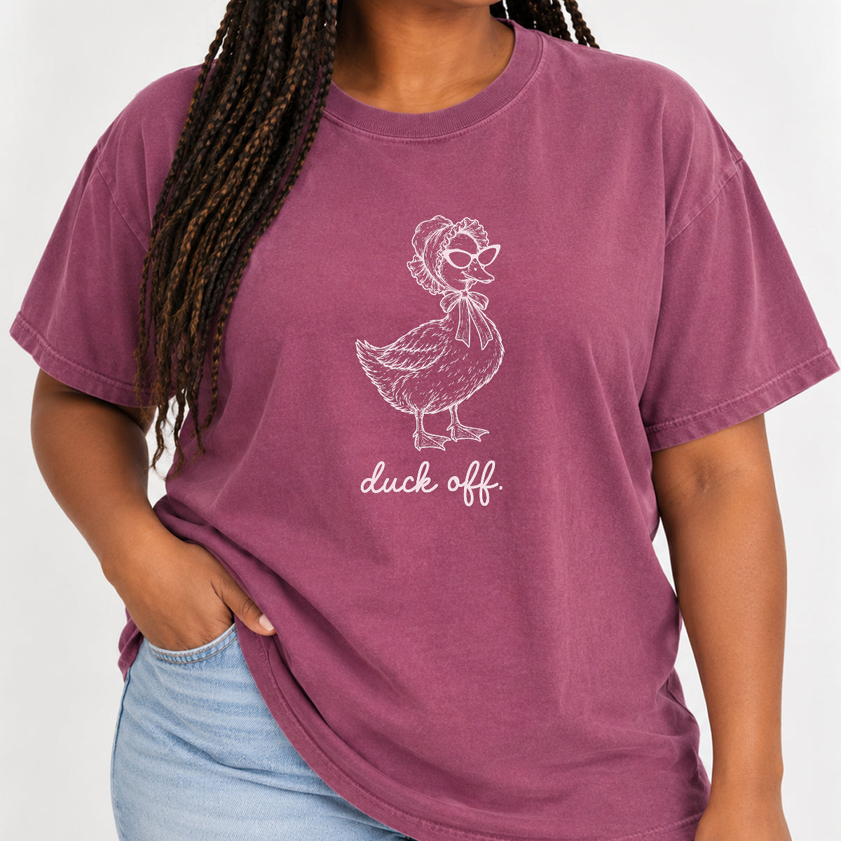Woman wearing the Duck Off tee in Berry with jeans, blush duck design on the chest