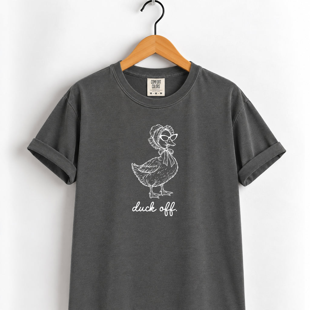 Duck Off tee in Pepper on a wooden hanger, white duck design center chest