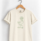 Duck Off tee in Ivory on a wooden hanger, sage green duck design center chest