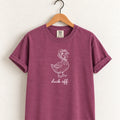 Duck Off tee in Berry on a wooden hanger, blush duck design center chest