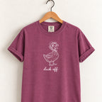 Duck Off tee in Berry on a wooden hanger, blush duck design center chest