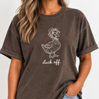 Woman wearing the Duck Off tee in Espresso, off-white duck in a bonnet design on the chest